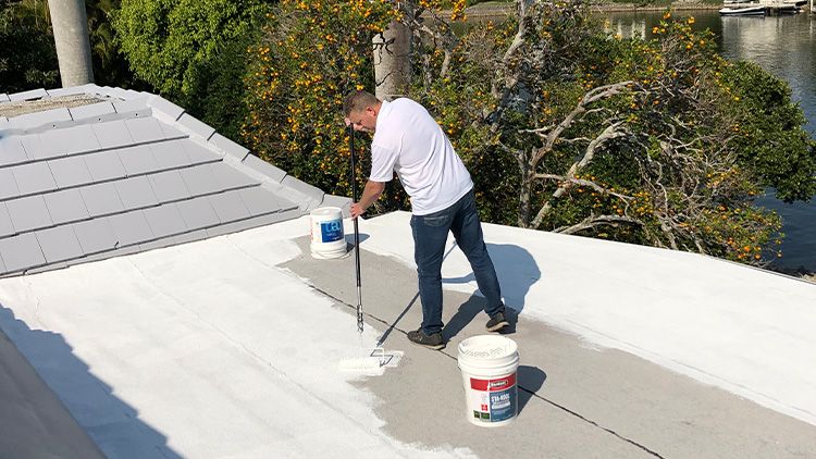 Naples painter applying a coat to a roof